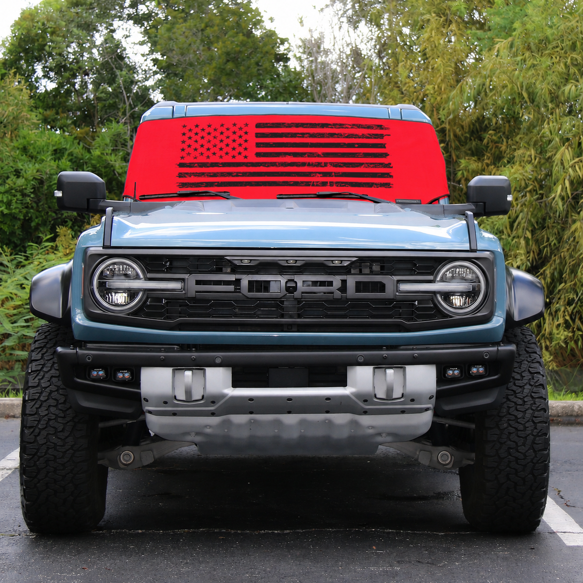 Ford Bronco Raptor front view with red distressed American flag Solar Shield on windshield | Spider Web Shade