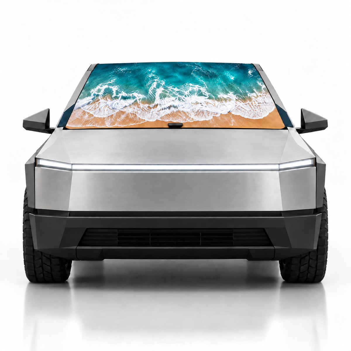 Front view of silver Tesla Cybertruck with Coastal Escape print (ocean waves on beach) Solar Shield on windshield | Spider Web Shade