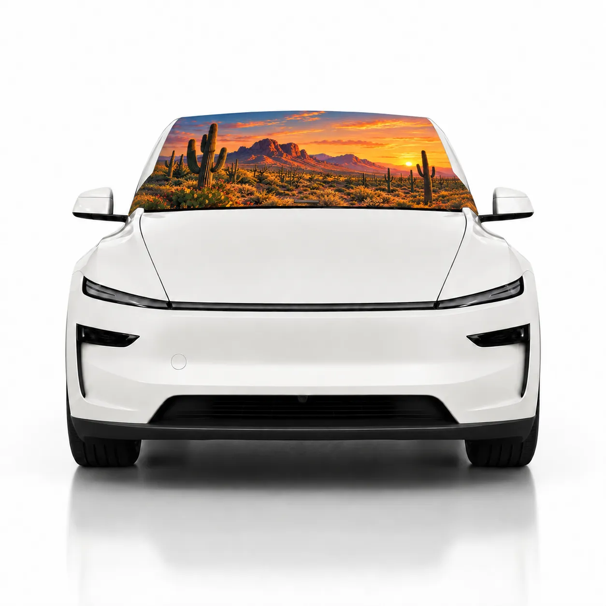 Front view of white Tesla Model Y with Desert Glow print (desert sunset with saguaro cacti) Solar Shield on windshield | Spider Web Shade