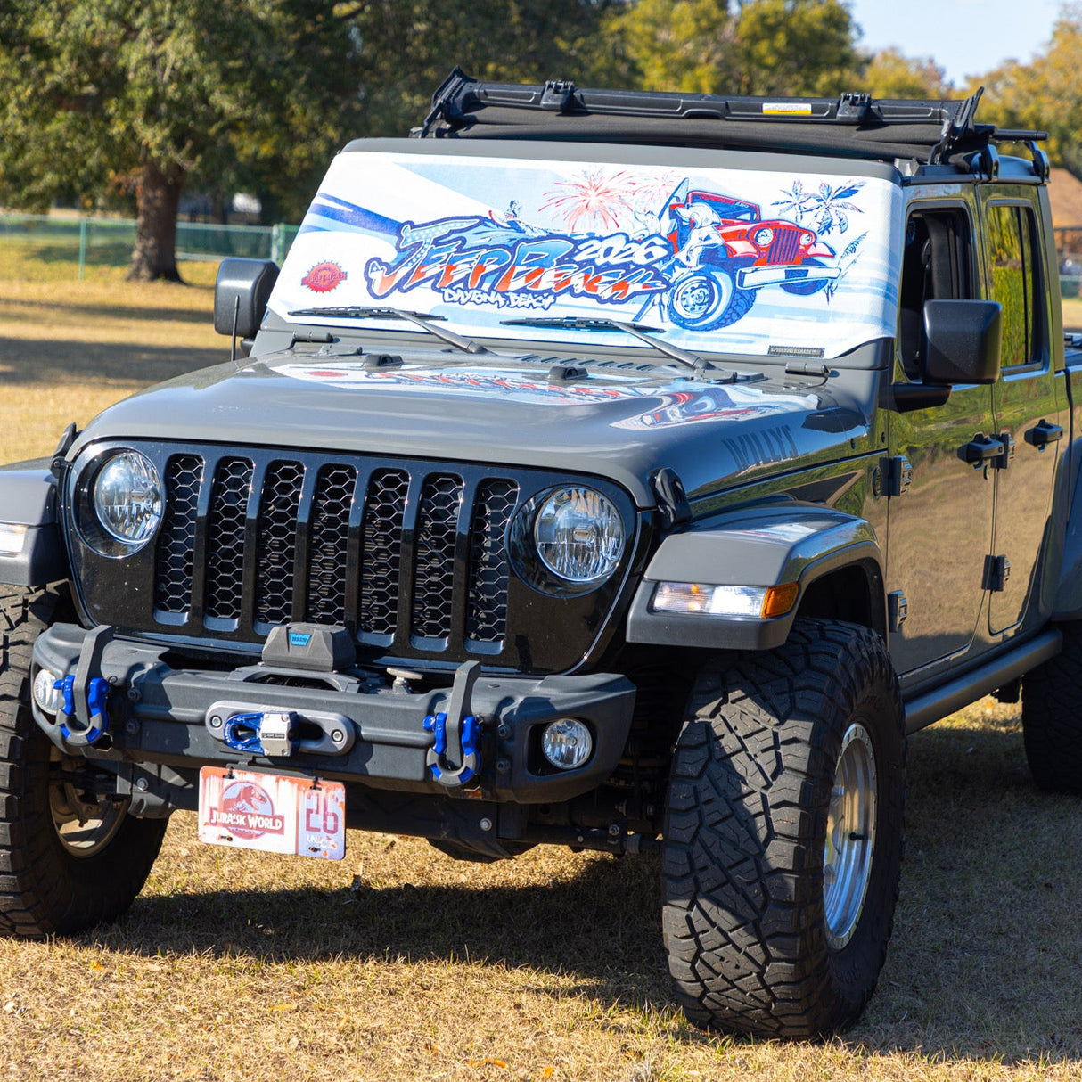 Jeep Wrangler with a custom wrap on a grassy field