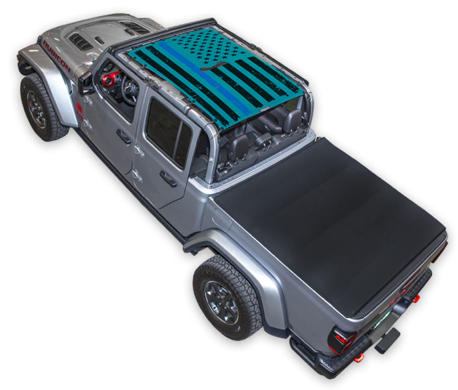 Silver Gladiator JT four door Jeep with Distressed Thin Blue Line tactical Flag teal SPIDERWEBSHADE shade on top that covers front and rear passenger seats.