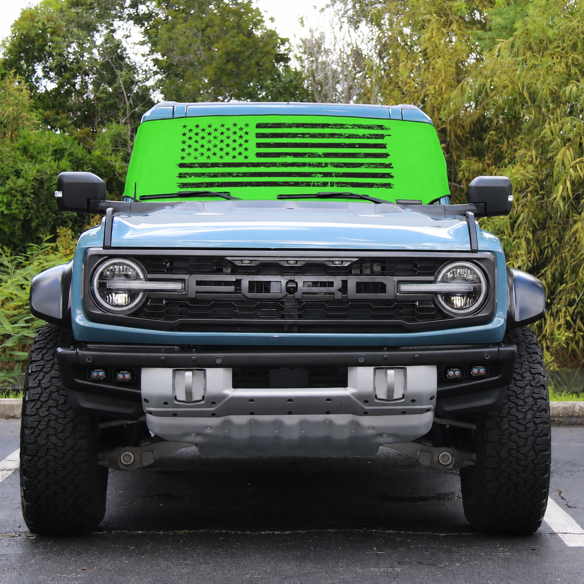 Ford Bronco Raptor front view with lime green distressed American flag Solar Shield on windshield | Spider Web Shade