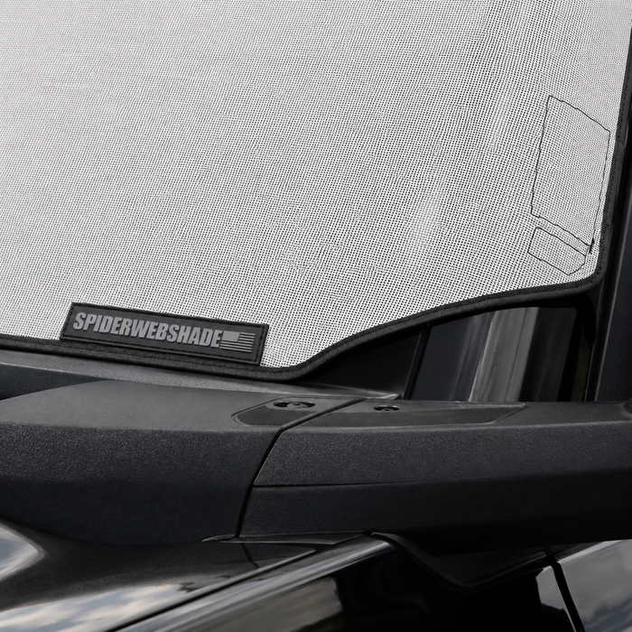 Close-up of SpiderWebShade label on Solar Shield edge inside windshield | Spider Web Shade