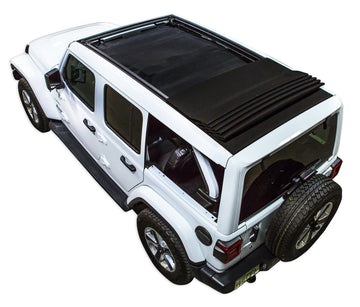 White  JL four door Power Top Jeep with black SPIDERWEBSHADE shade on top that covers front and rear passenger seats.