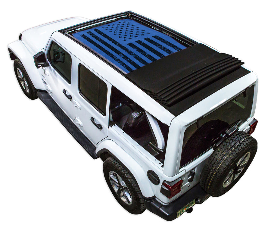 White JL four door Power Top Jeep with Distressed Tactical American Flag blue SPIDERWEBSHADE shade on top that covers front and rear passenger seats.
