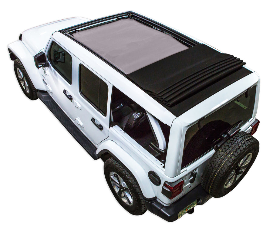 White  JL four door Power Top Jeep with grey SPIDERWEBSHADE shade on top that covers front and rear passenger seats.