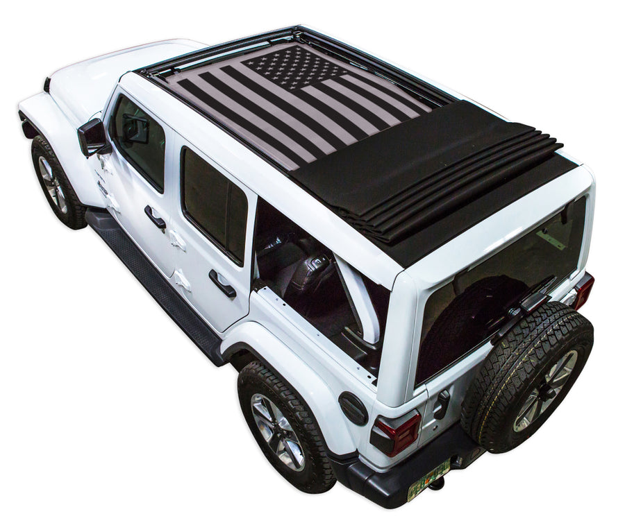 White JL four door Power Top Jeep with Solid Tactical American Flag grey SPIDERWEBSHADE shade on top that covers front and rear passenger seats.