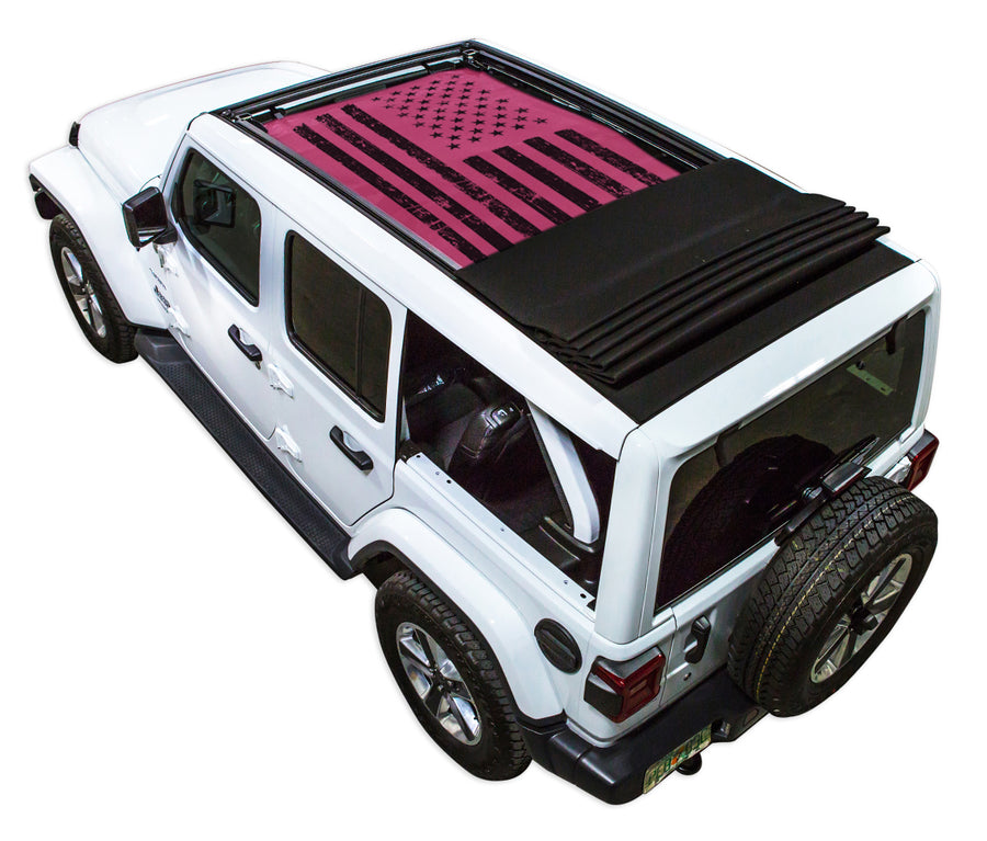 White JL four door Power Top Jeep with Distressed Tactical American Flag pink SPIDERWEBSHADE shade on top that covers front and rear passenger seats.