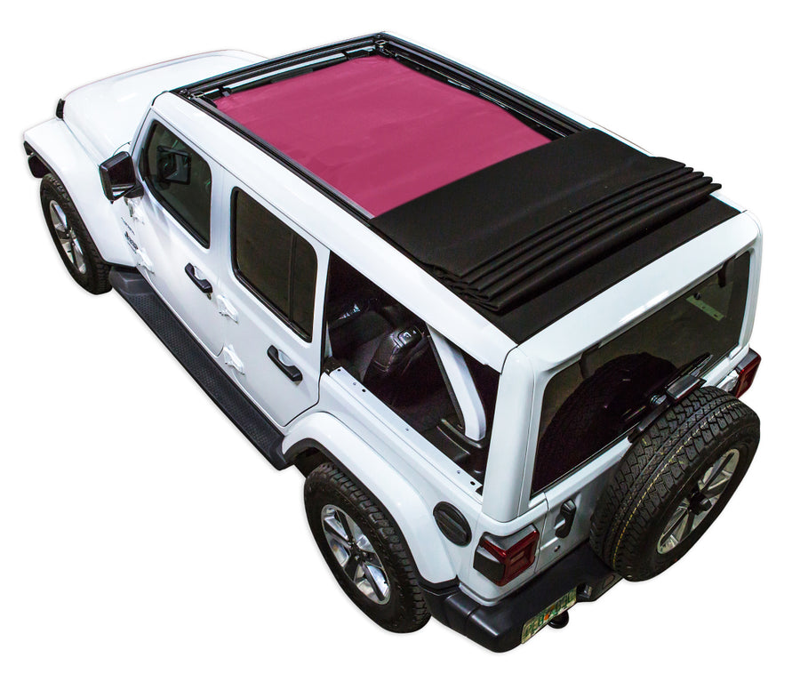 White JL four door Power Top Jeep with pink SPIDERWEBSHADE shade on top that covers front and rear passenger seats.