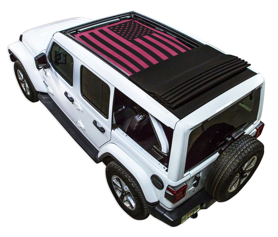 White JL four door Power Top Jeep with Solid Tactical American Flag pink SPIDERWEBSHADE shade on top that covers front and rear passenger seats.