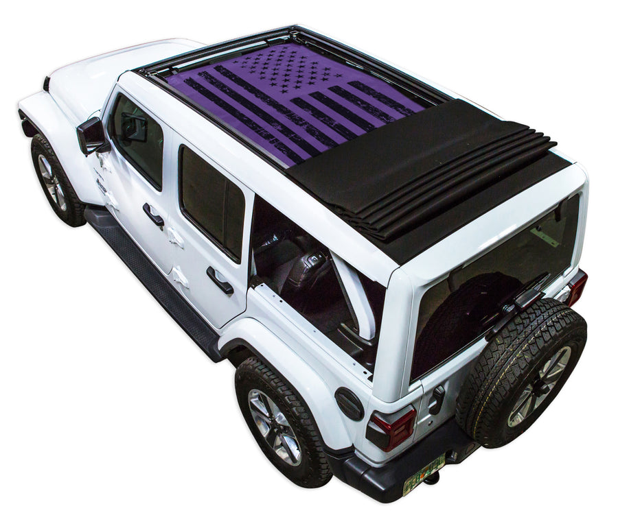 White JL four door Power Top Jeep with Distressed Tactical American Flag purple SPIDERWEBSHADE shade on top that covers front and rear passenger seats.