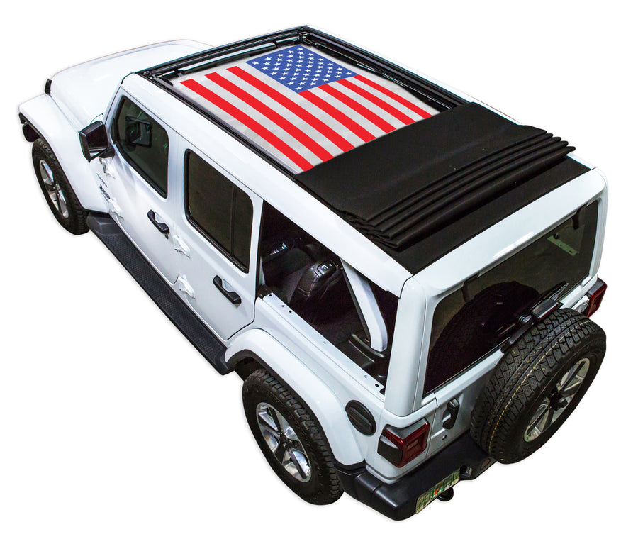 White JL four door Power Top Jeep with American Flag SPIDERWEBSHADE shade on top that covers front and rear passenger seats.