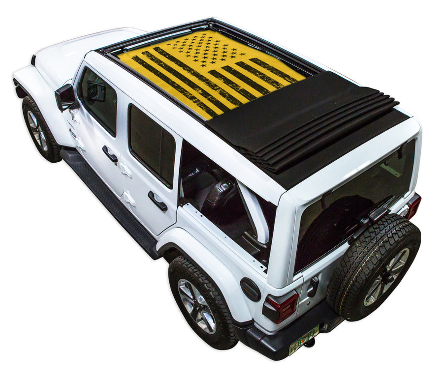 White JL four door Power Top Jeep with Distressed Tactical American Flag yellow SPIDERWEBSHADE shade on top that covers front and rear passenger seats.