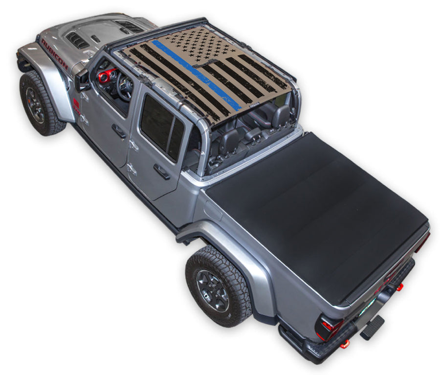 Silver Gladiator JT four door Jeep with Distressed Thin Blue Line tactical Flag tan SPIDERWEBSHADE shade on top that covers front and rear passenger seats.