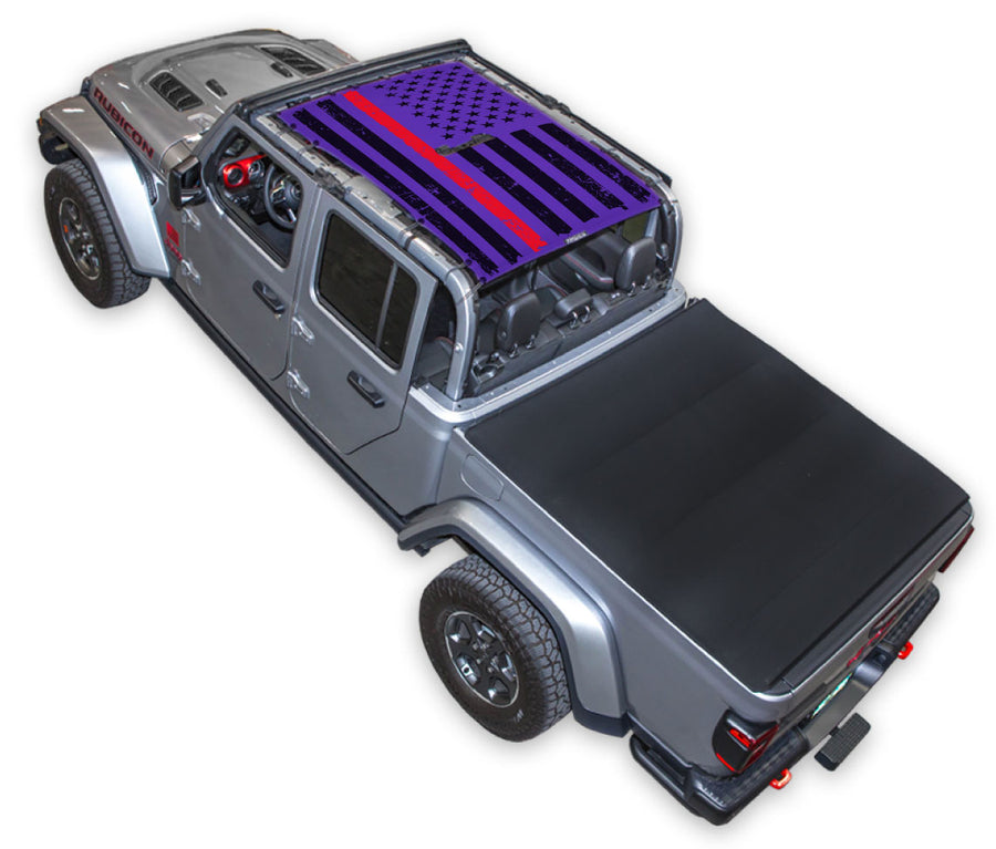 Silver Gladiator JT four door Jeep with Distressed Thin Red Line tactical Flag purple SPIDERWEBSHADE shade on top that covers front and rear passenger seats.