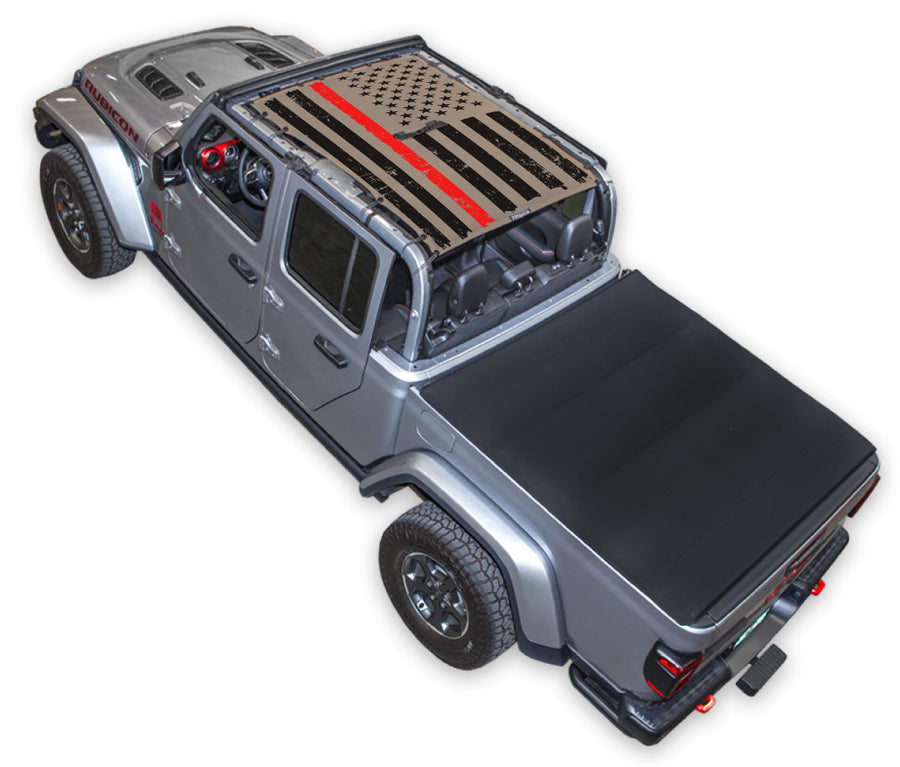 Silver Gladiator JT four door Jeep with Distressed Thin Red Line tactical Flag tan SPIDERWEBSHADE shade on top that covers front and rear passenger seats.