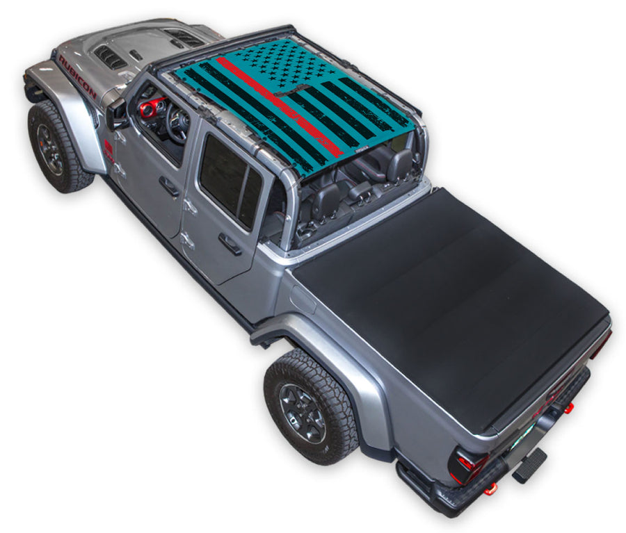 Silver Gladiator JT four door Jeep with Distressed Thin Red Line tactical Flag teal SPIDERWEBSHADE shade on top that covers front and rear passenger seats.