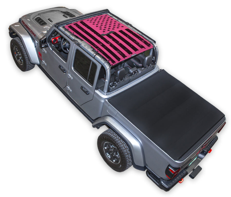Silver Gladiator JT four door Jeep with Distressed tactical Flag Pink SPIDERWEBSHADE shade on top that covers front and rear passenger seats.