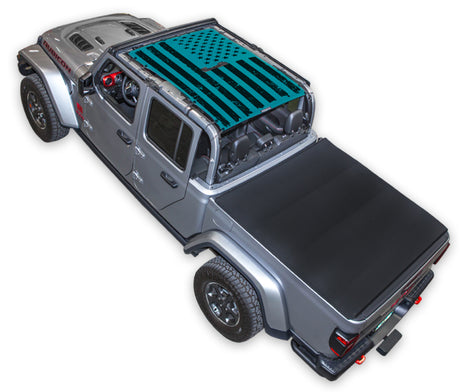 Silver Gladiator JT four door Jeep with Distressed tactical Flag teal SPIDERWEBSHADE shade on top that covers front and rear passenger seats.