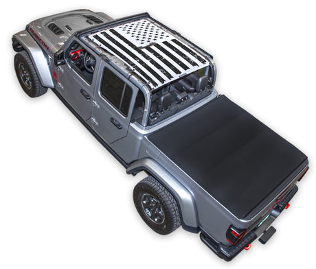 Silver Gladiator JT four door Jeep with Distressed tactical Flag white  SPIDERWEBSHADE shade on top that covers front and rear passenger seats.