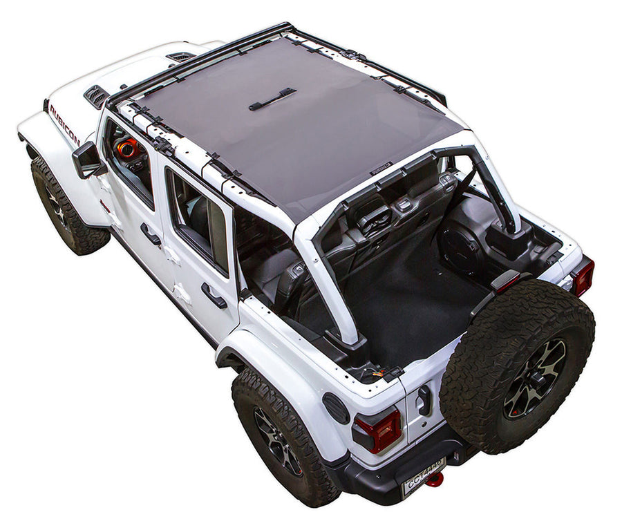 White Rubicon JL four door Jeep with grey SPIDERWEBSHADE shade on top that covers front and rear passenger seats. 