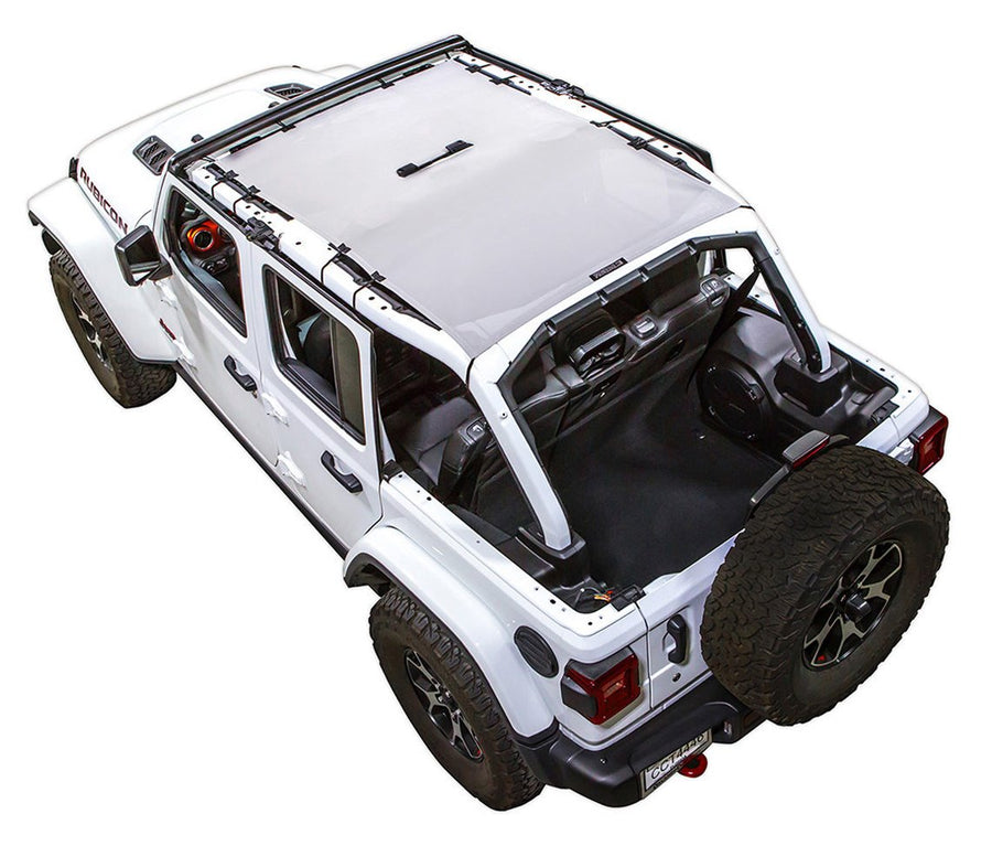 White Rubicon JL four door Jeep with white SPIDERWEBSHADE shade on top that covers front and rear passenger seats.